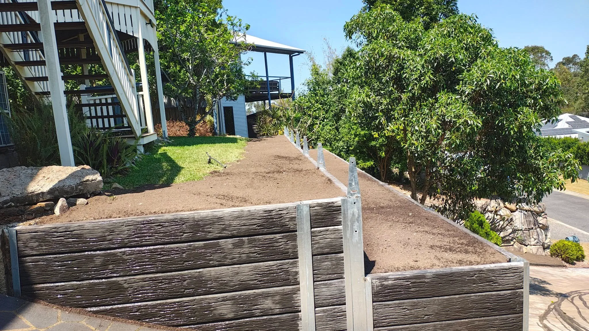 Concrete sleeper retaining wall for a commercial property
